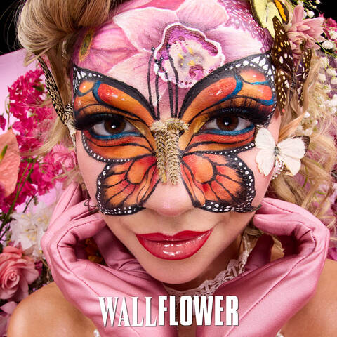 Section highlighting Royal Butter Glosses with two gloss tubes on a pink floral background and product description. Displays the campaign Wallflower look.