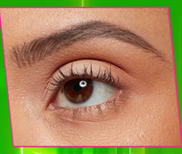 Close-up of a brown eye with well-defined eyelashes and eyebrow, set against a bright green background.