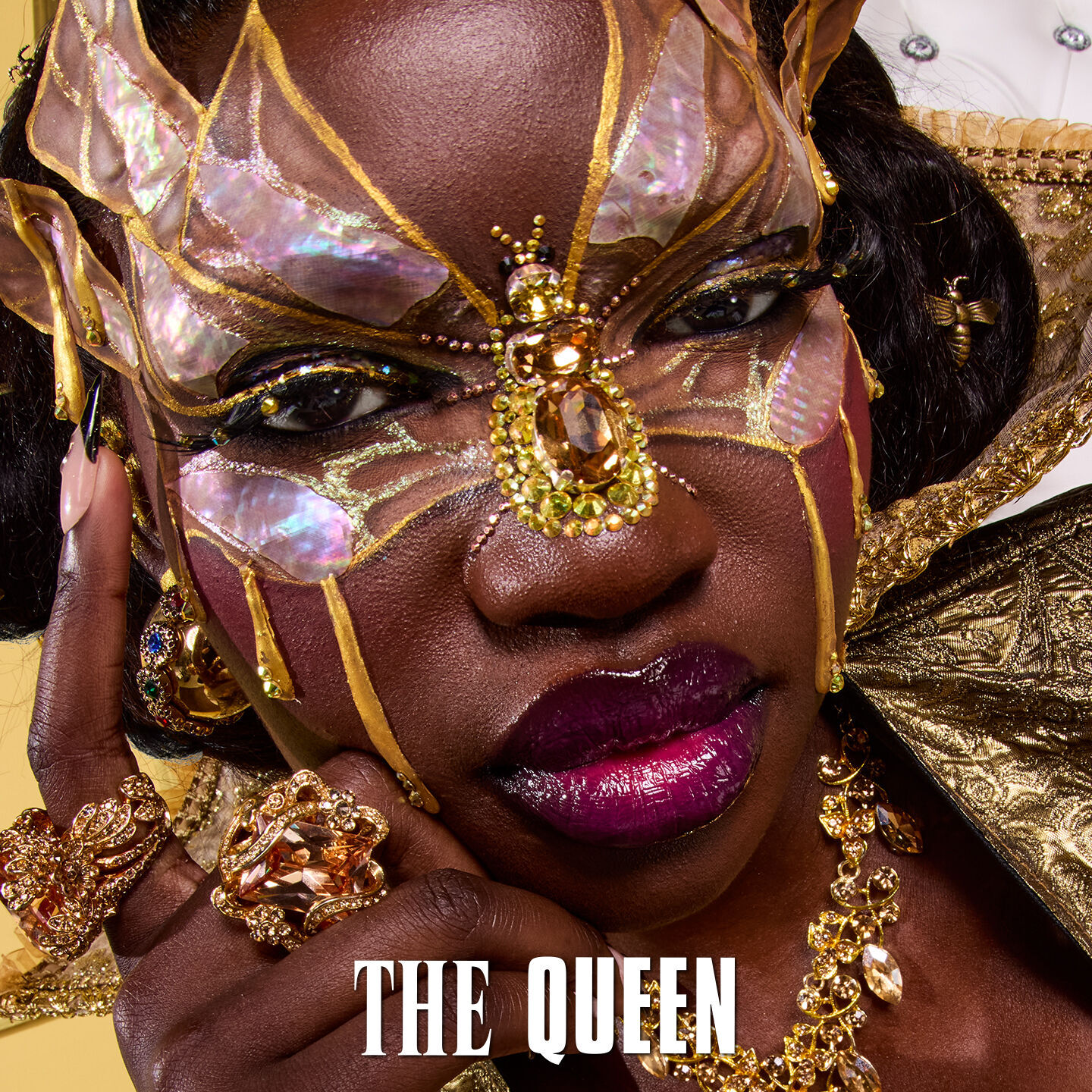 The Queen section showcasing NYX Royal Epic Ink Liner Glitz on a gold floral background.