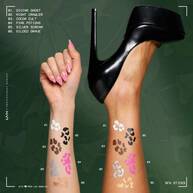 NYX Professional Makeup Party Animals SFX Face & Body Paint Sticks used to create white, brown and pink decorative designs on a model’s arms.