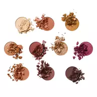 Presents an overhead view of ten individual piles of loose eyeshadow pigment, representing each shade in the NYX Professional Makeup Holiday Gingerbaddie Palette.